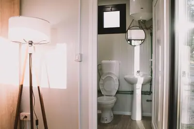 a bathroom with a toilet and a sink at Neptun Beach & Forest Cabins in Ulcinj