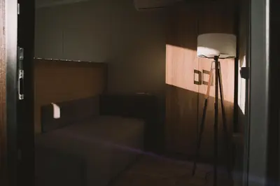 a room with a lamp in the corner of a room at Neptun Beach & Forest Cabins in Ulcinj