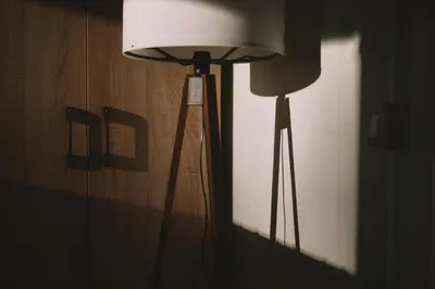 a lamp in a room with a light on a wall at Neptun Beach & Forest Cabins in Ulcinj
