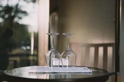 two wine glasses sitting on top of a table at Neptun Beach & Forest Cabins in Ulcinj