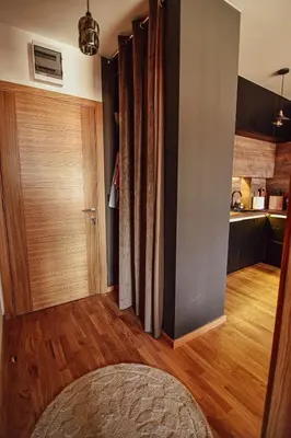 a living room with a wooden floor and a kitchen at Apartment with sea view 5 minutes from the beach in Budva