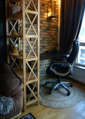 a chair sitting in front of a book shelf at Apartment with sea view 5 minutes from the beach in Budva