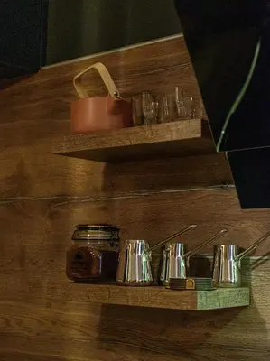a wooden shelf with glasses and a jar on it at Apartment with sea view 5 minutes from the beach in Budva