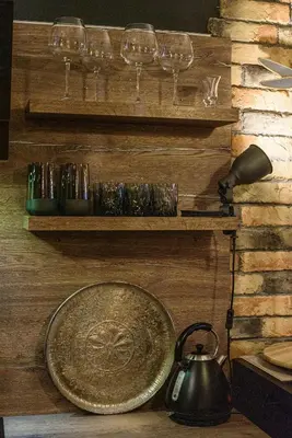 a plate on a wall with glasses and a tea kettle at Apartment with sea view 5 minutes from the beach in Budva