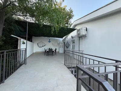 a patio with a table and chairs in a building at Gio Bella in Sutomore