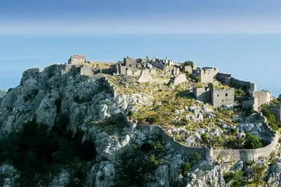 a castle on top of a mountain near the ocean at Gio Bella in Sutomore