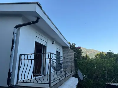 a balcony of a white house with a window at Gio Bella in Sutomore