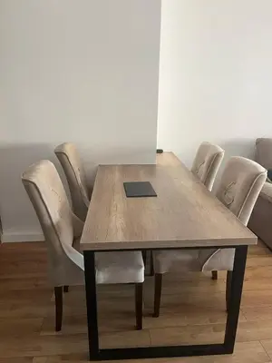a wooden table with chairs and a laptop on it at Apartmants Taco Ulcinj in Ulcinj