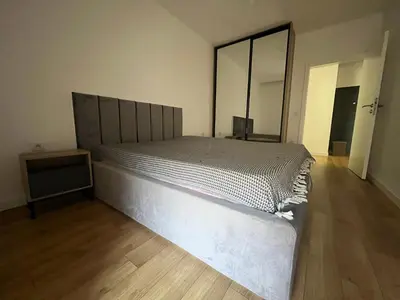 a large bed in a room with a wooden floor at Apartmants Taco Ulcinj in Ulcinj