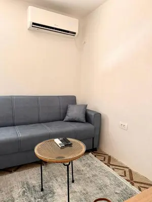 a living room with a couch and a table at Tatjana apartman blue in Sutomore