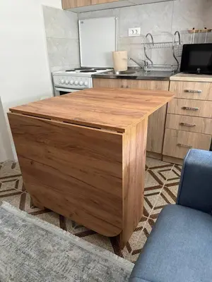 a kitchen with a wooden island in a kitchen at Tatjana apartman blue in Sutomore