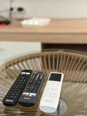 two remote controls sitting on top of a chair at Tatjana apartman blue in Sutomore