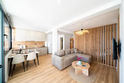 a living room with a couch and a table at Latković Charming Studio in Ulcinj