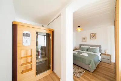 a bedroom with a bed and a door to a balcony at Latković Charming Studio in Ulcinj
