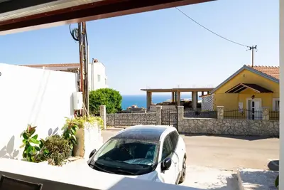 a white car parked in front of a house at Latković Charming Studio in Ulcinj