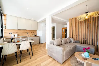 a living room and kitchen with a couch and a table at Latković Charming Studio in Ulcinj