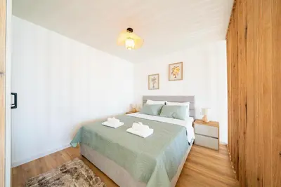 a bedroom with a bed with two towels on it at Latković Charming Studio in Ulcinj