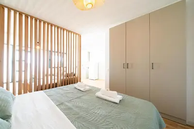 a bedroom with a bed with two towels on it at Latković Charming Studio in Ulcinj
