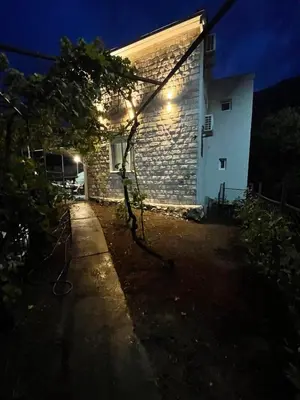 a house with a light on the side of it at night at Apartmani Baila in Ðurmani