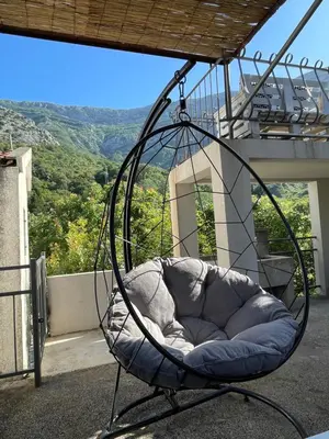 a hanging chair on a balcony with a view at Apartmani Baila in Ðurmani