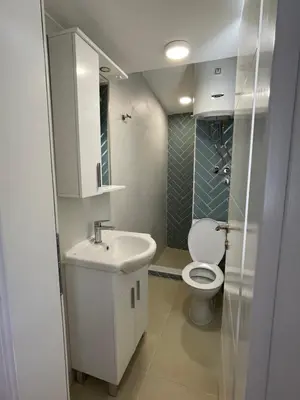 a bathroom with a white sink and a toilet at Apartmani Baila in Ðurmani