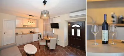 a kitchen with a bottle of wine and a wine glass at Kuzman Apartments in Kotor
