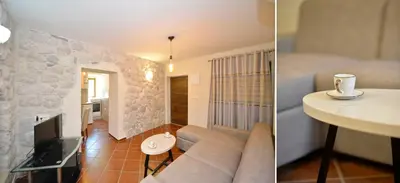 a living room with a couch and a tv and a living room at Kuzman Apartments in Kotor