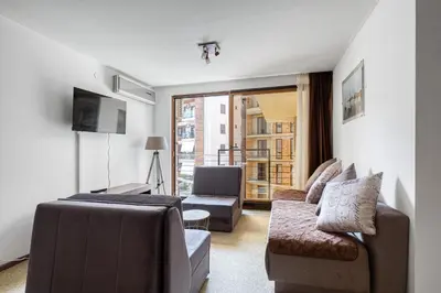 a living room with a couch and a tv at Cihan Apartment in Budva