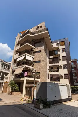 a tallartment building with a street in front of it at Cihan Apartment in Budva
