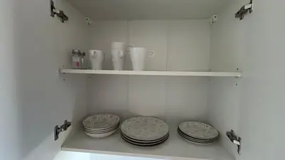 a kitchen with three plates sitting on a shelf at Stanovi VR in Bar