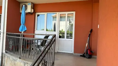a porch with a door and an umbrella and a vacuum at Stanovi VR in Bar