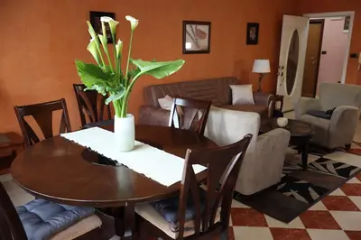 a living room with a table with a vase of flowers on it at Apartment Lux in Bar