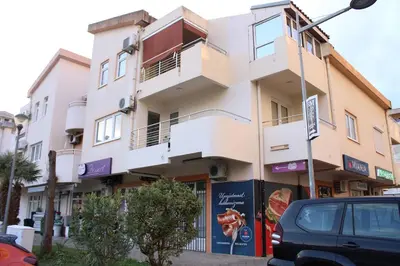 a building with a car parked in front of it at Apartment Lux in Bar
