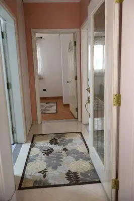 a hallway with a door and a rug on the floor at Apartment Lux in Bar