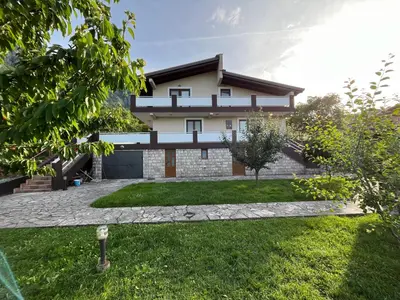 a house with a green yard in front of it at Mlatkovina in Gluhi Do