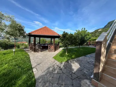 a gazebo with a table in a yard at Mlatkovina in Gluhi Do