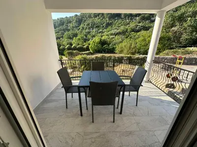 a table and chairs on a balcony with a view at Apartman Aki 2 in Bar