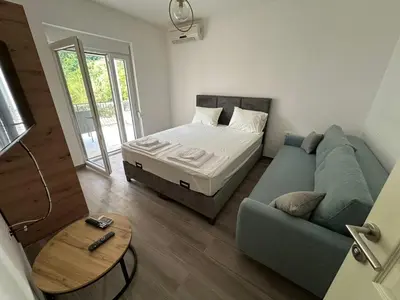 a living room with a couch and a bed at Apartman Aki 2 in Bar