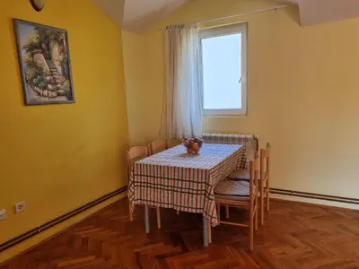 a dining room with a table and chairs and a window at Apartment Natasha in Petrovac na Moru