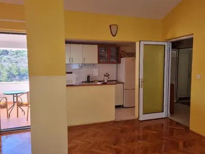 a kitchen with yellow walls and a table and a table at Apartment Natasha in Petrovac na Moru