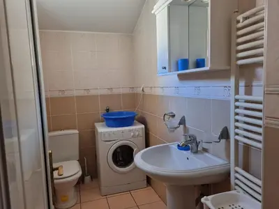 a small bathroom with a washing machine and a sink at Apartment Natasha in Petrovac na Moru