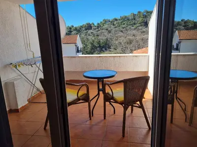 a balcony with a table and chairs and a view at Apartment Natasha in Petrovac na Moru
