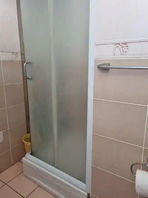 a shower with a glass door in a bathroom at Apartment Natasha in Petrovac na Moru