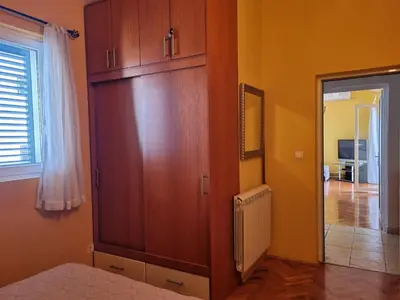 a room with a large wooden cabinet and a hallway at Apartment Natasha in Petrovac na Moru