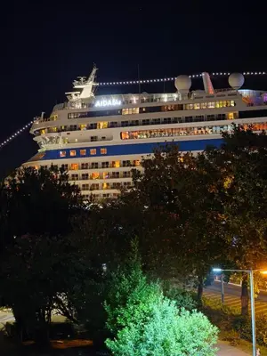 a large cruise ship is docked at night at Chill out Spa Studio in Kotor