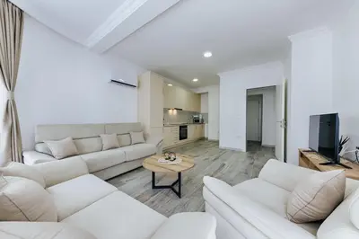 a white living room with white couches and a table at Villa Blue Haven in Ulcinj