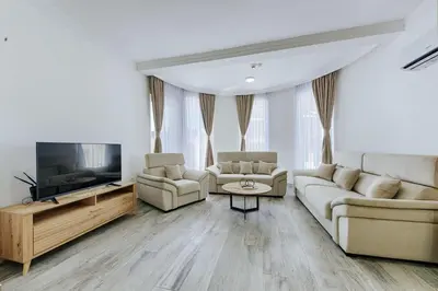 a living room with two couches and a flat screen tv at Villa Blue Haven in Ulcinj