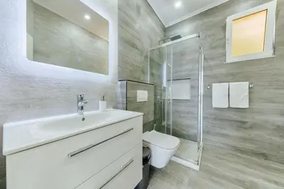 a bathroom with a sink and a shower and a toilet at Villa Blue Haven in Ulcinj