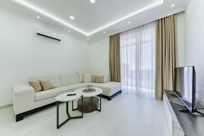 a living room with a white couch and a television at Villa Blue Haven in Ulcinj