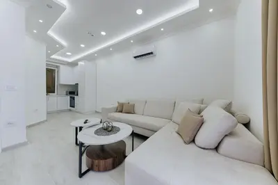 a living room with a white couch and a table at Villa Blue Haven in Ulcinj